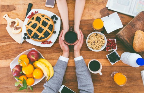 couple having breakfast in the morning at home. Rich breakfast on the table and hot coffee