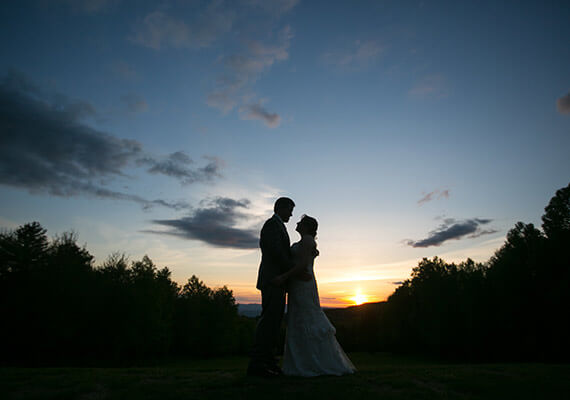 Silhouette of bride and groom at sunset