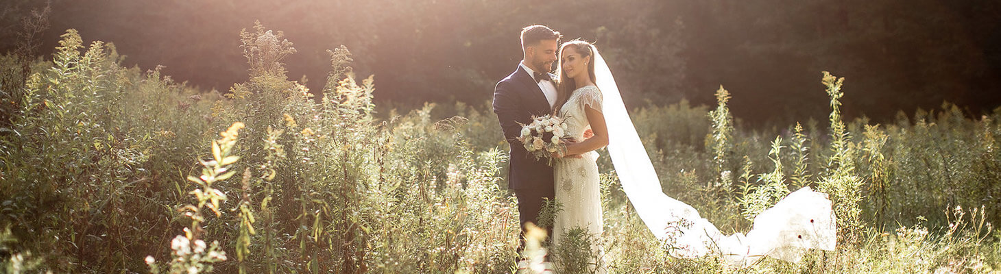 Bride and groom in the tall grass